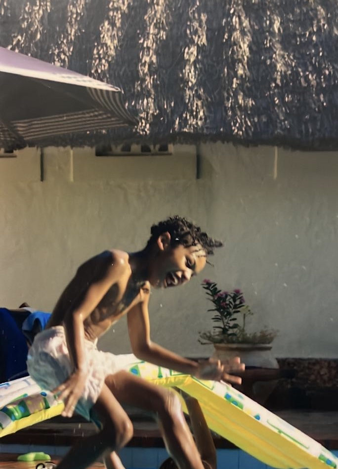 Sidney playing in the pool as a child in Kenya
