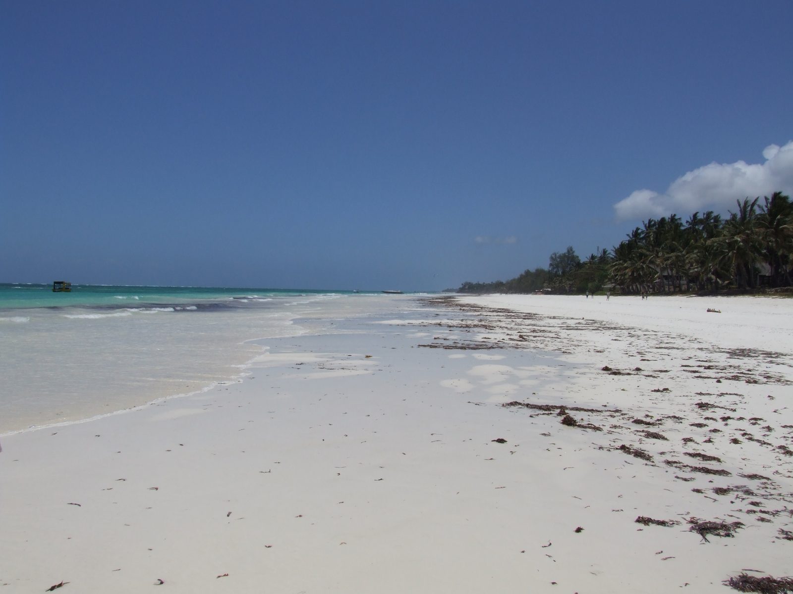 White sand beach and dhow on the Kenyan coast at Diani