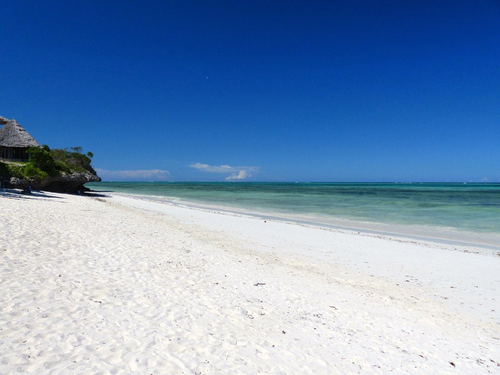 White sand beach and dhow on the Kenyan coast at Diani